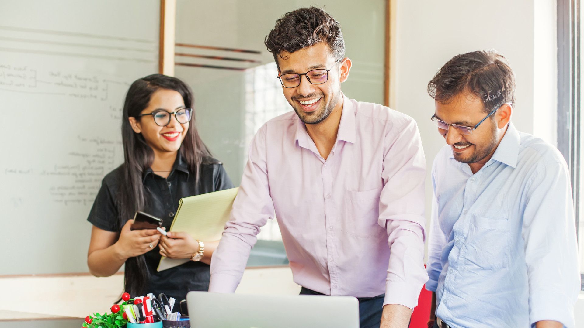 three colleagues smiling with each other