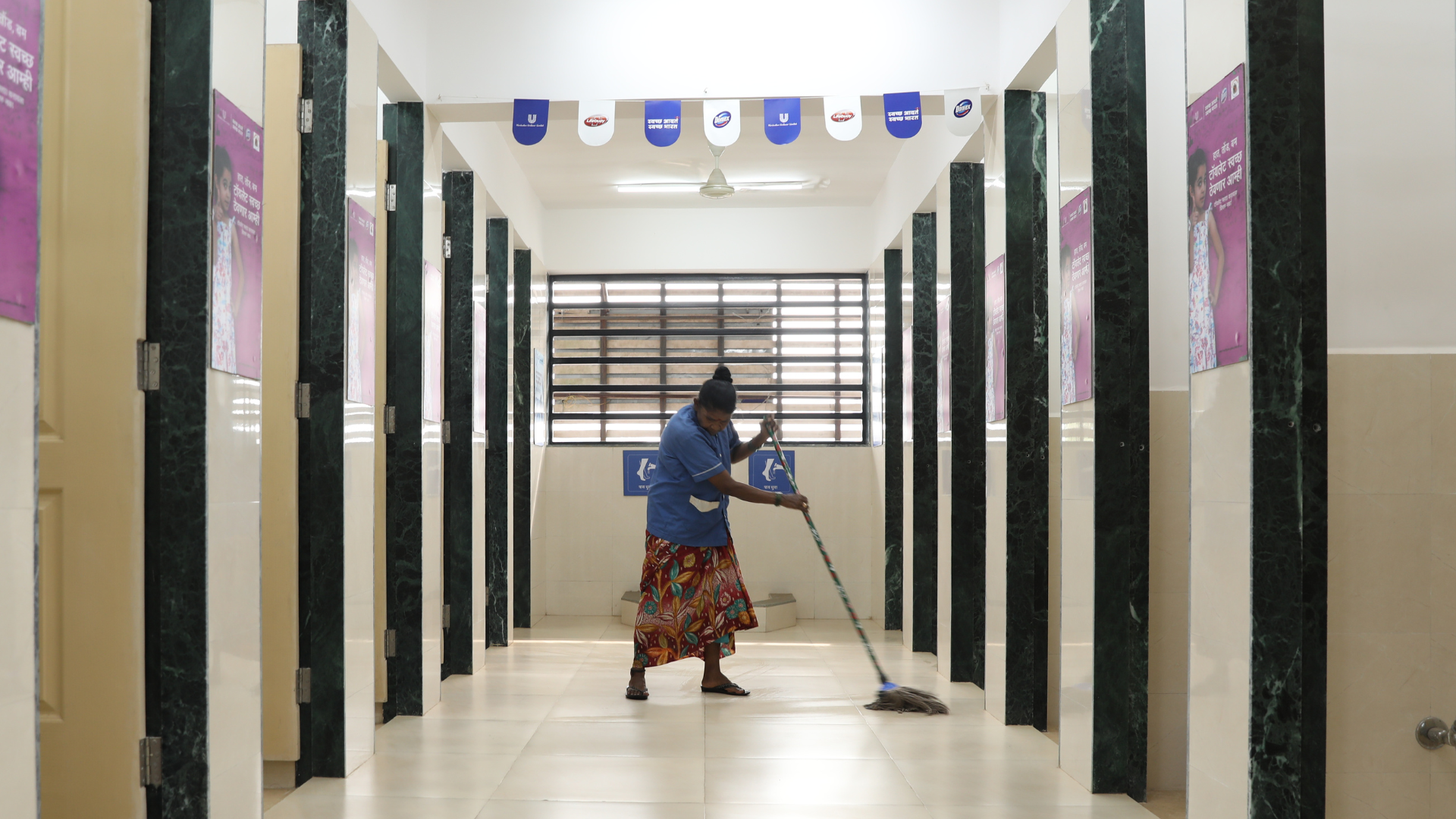 A cleanliness worker cleaning HUL’s Suvidha centre