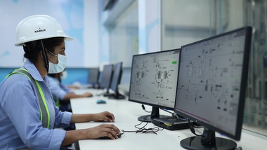 A factory woman working on a computer