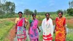 A picture if happy women farmers alongside a water pond