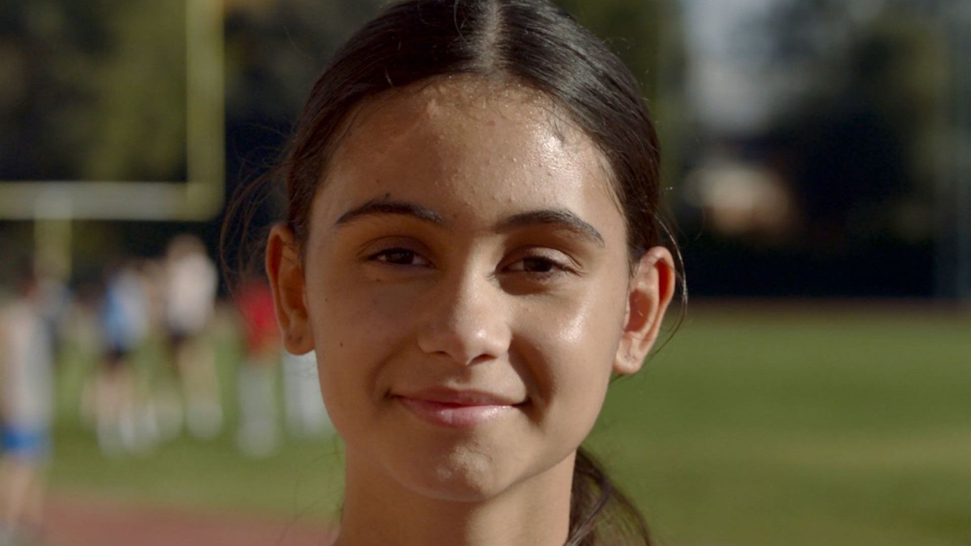 A picture of a young girl wearing a white and blue top.