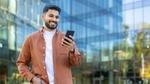 Indian man holding a phone