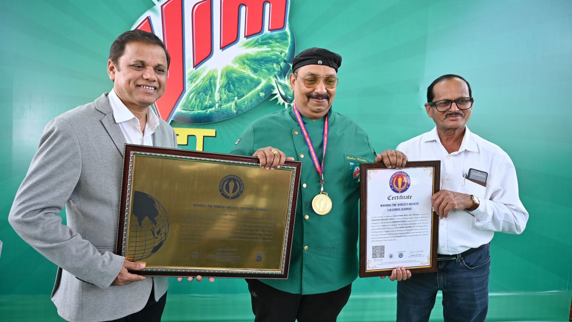 Three men holding an award.