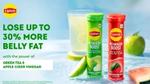 Two Lipton Metabolism Boost tubes, green apple and watermelon flavors, with a glass of the drink.