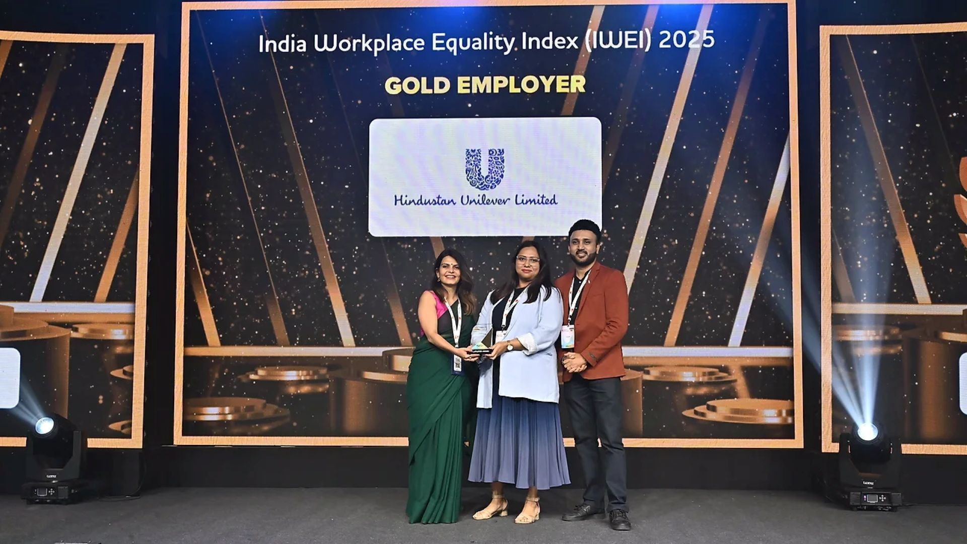 Three people with the award for championing equality at India Workplace Equality Index 2025.