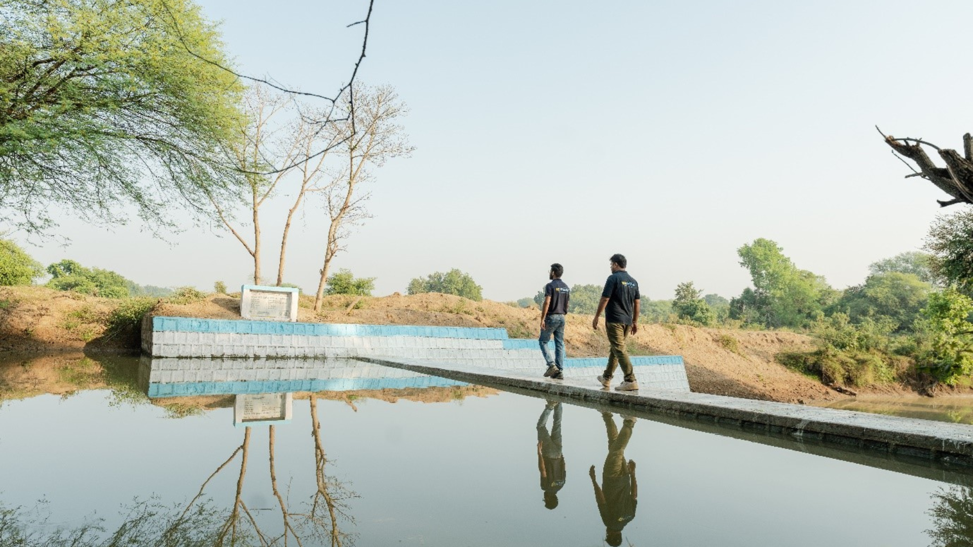 Men walking over water on a bridge
