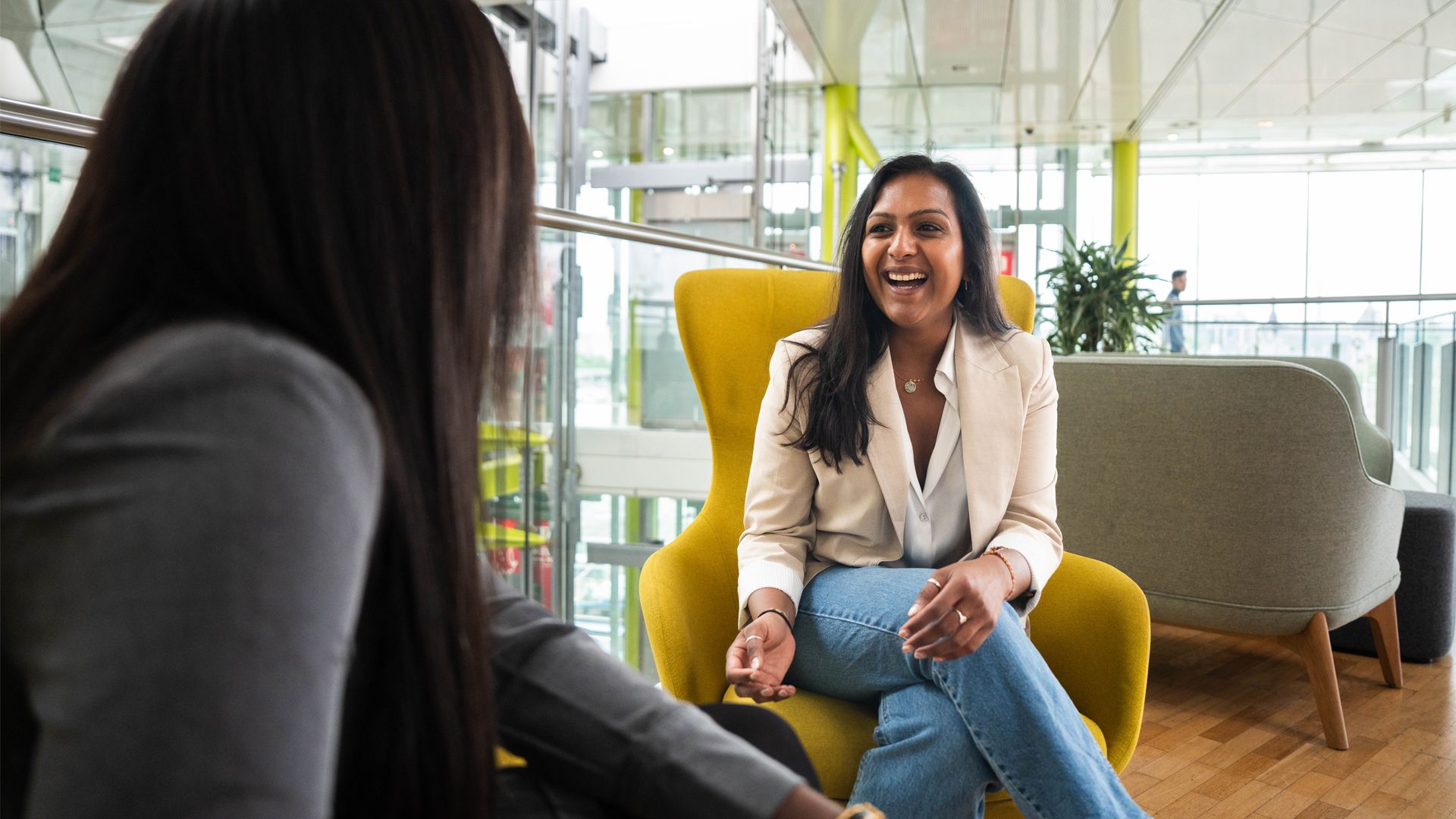 Two women having a conversation smiling and laughing