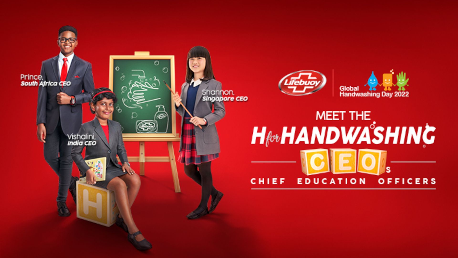 Three children post with an easel. Copy reads 'Meet the H for Handwashing Chief Education Officers'