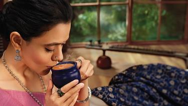 A woman sipping her drink