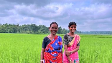 Two women in an agricultural field.