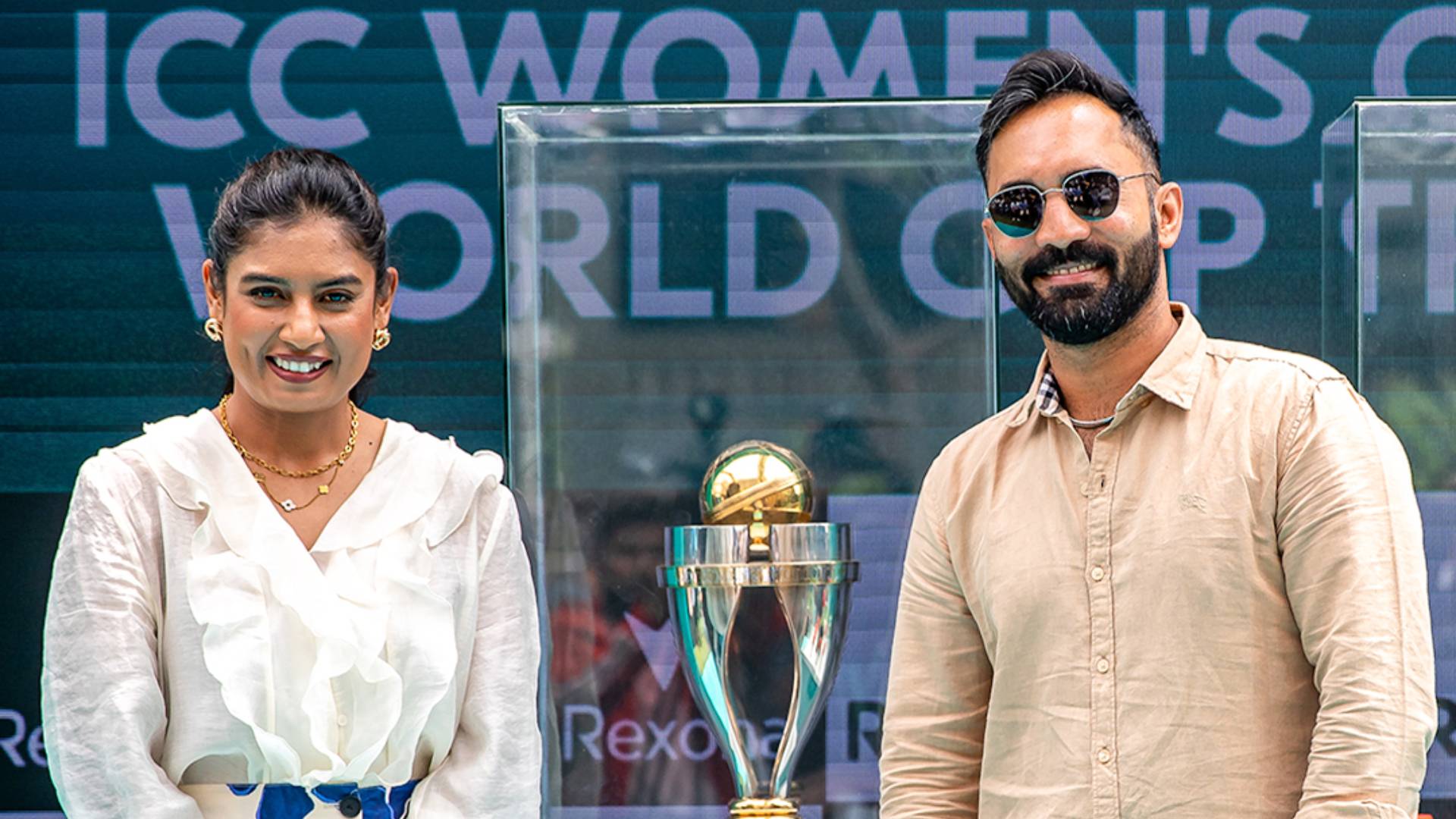 Two people standing with ICC Women's Cricket World Cup trophy.