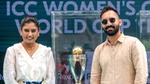 Two people standing with ICC Women's Cricket World Cup trophy.
