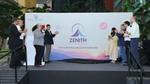 Employees stand on stage applauding the unveiling of the Zenith corporate platform banner