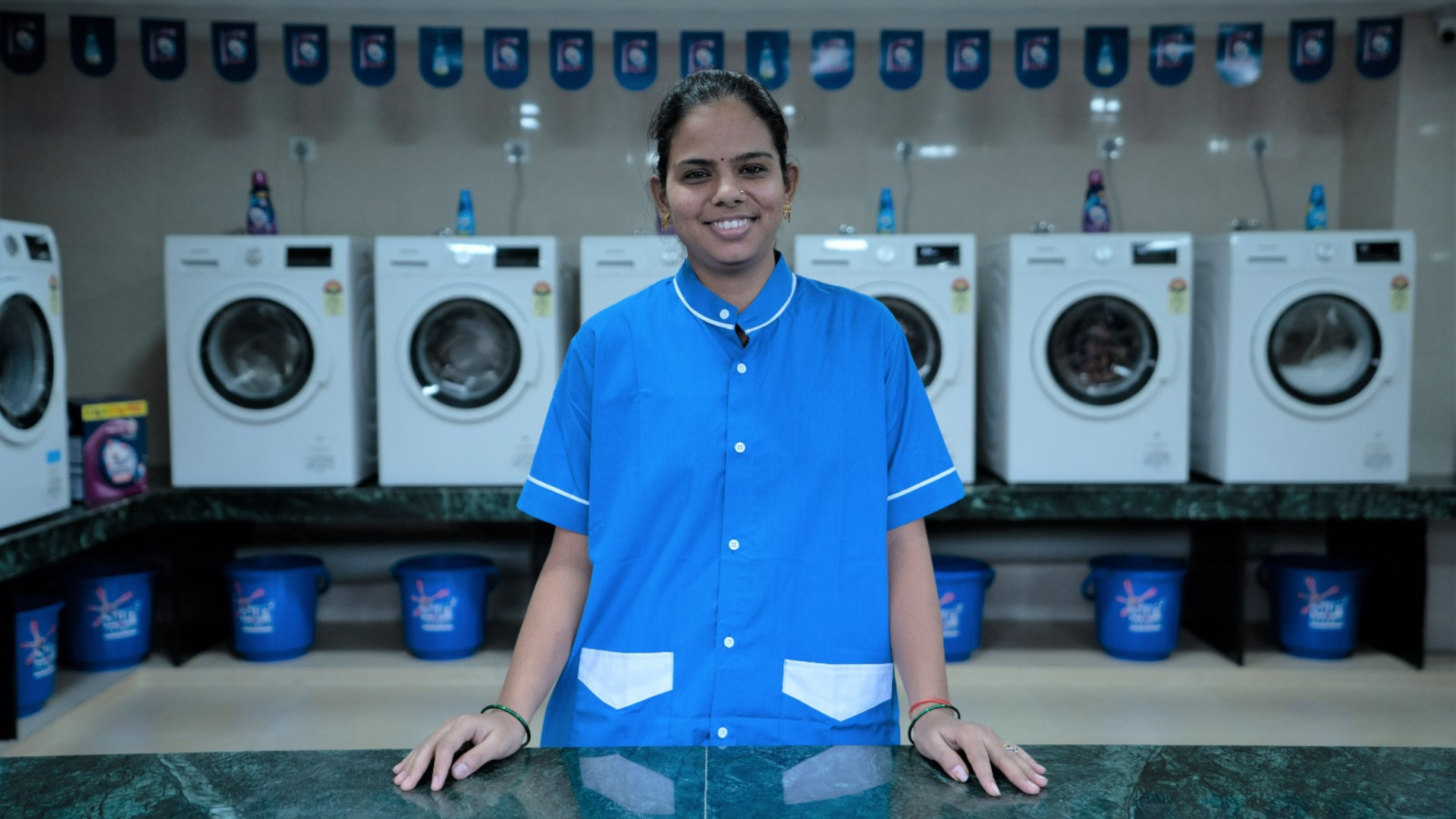 A lady worker managing the laundromat section at HUL’s Suvidha centre
