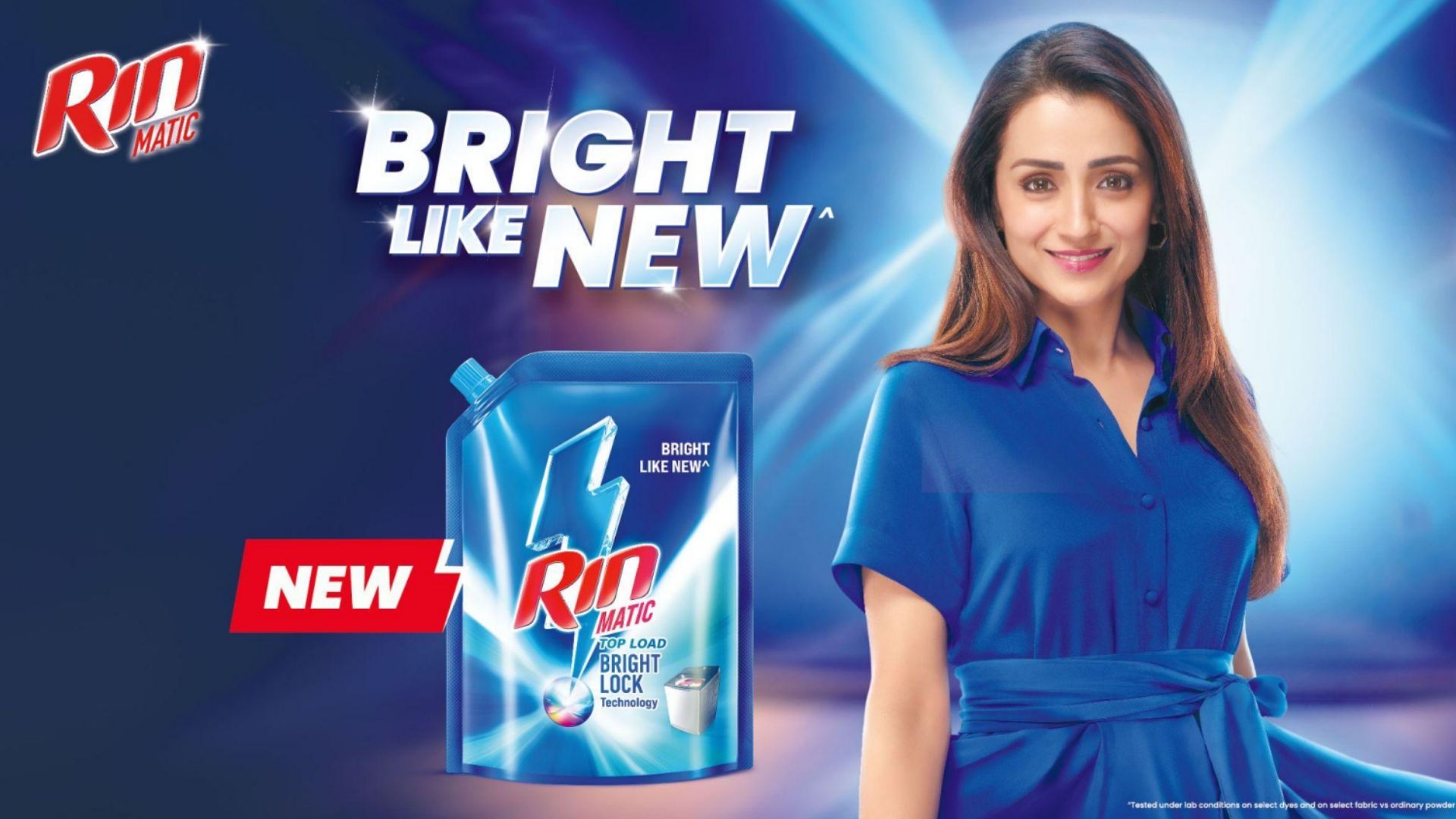 Rin Matic ad showing a woman in a bright blue dress and a detergent pack with the tagline "Bright Like New."