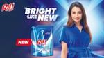 Rin Matic ad showing a woman in a bright blue dress and a detergent pack with the tagline "Bright Like New."