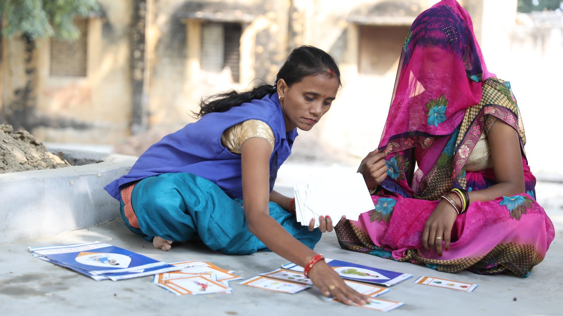 Two women on the floor doing activities 