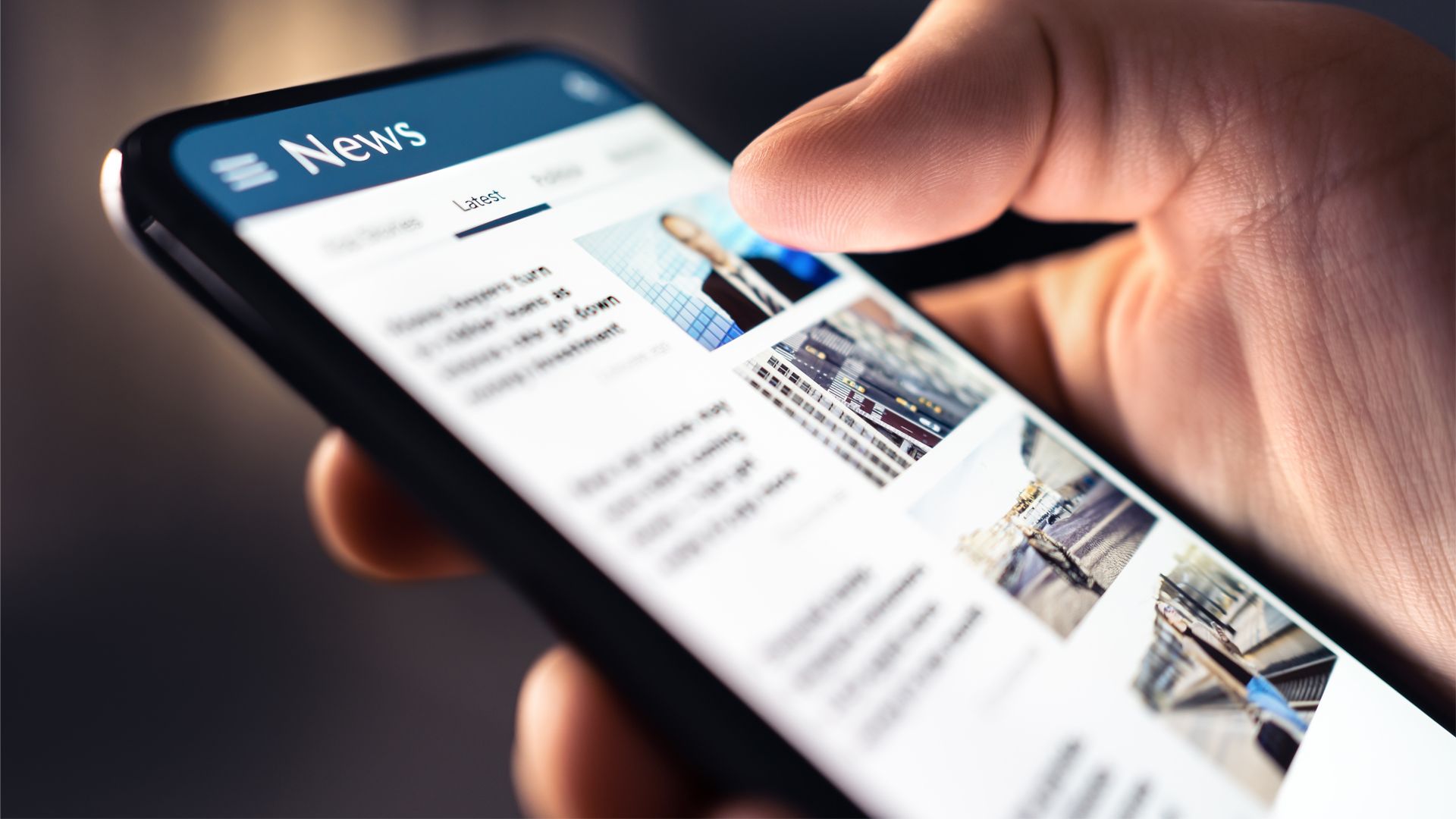 A close up of someone holding a mobile phone and scrolling through articles in a newsfeed