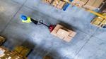 An aerial view of a man pulling a trolley through a warehouse loading bay