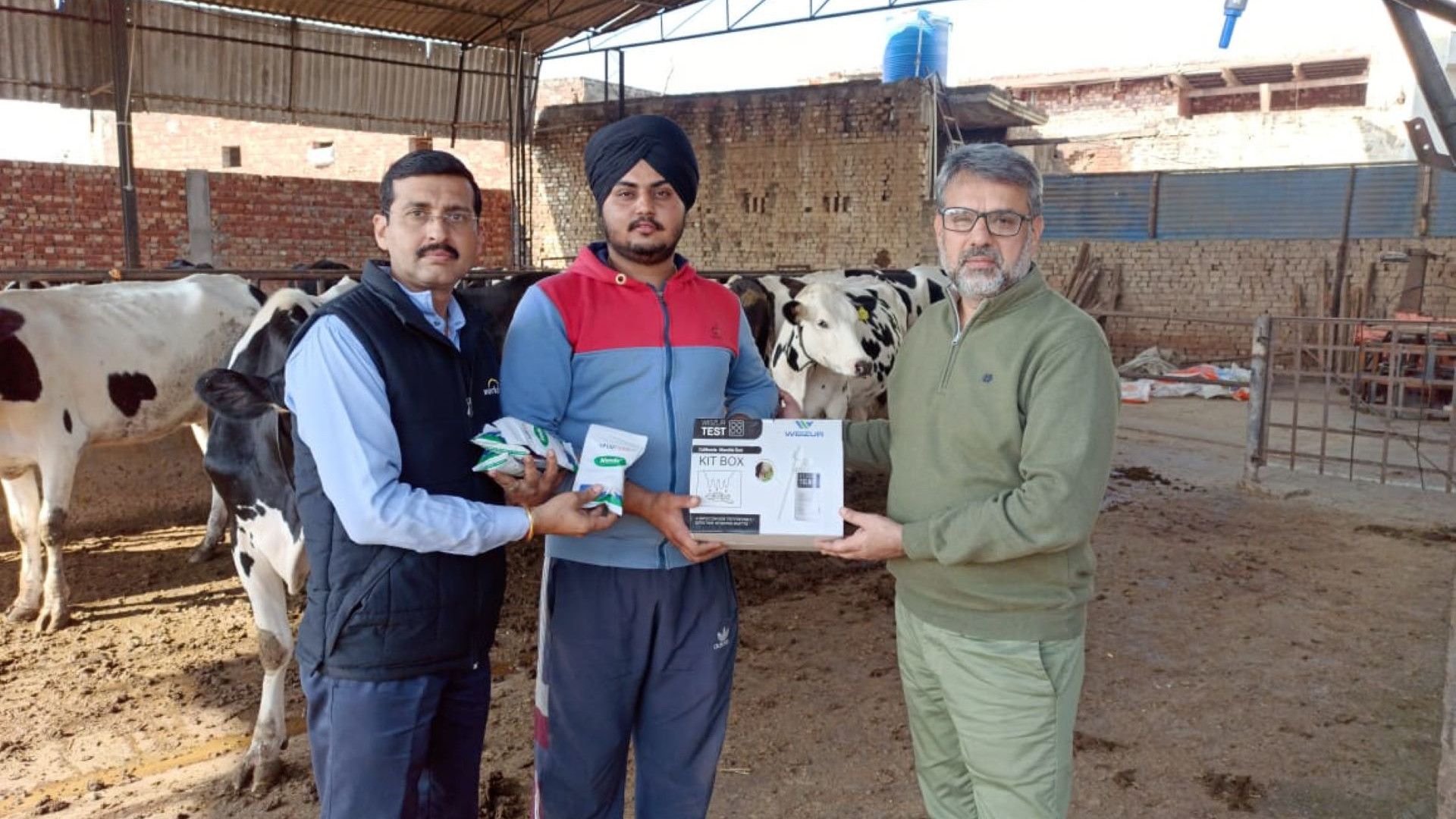 Three men at a farm.