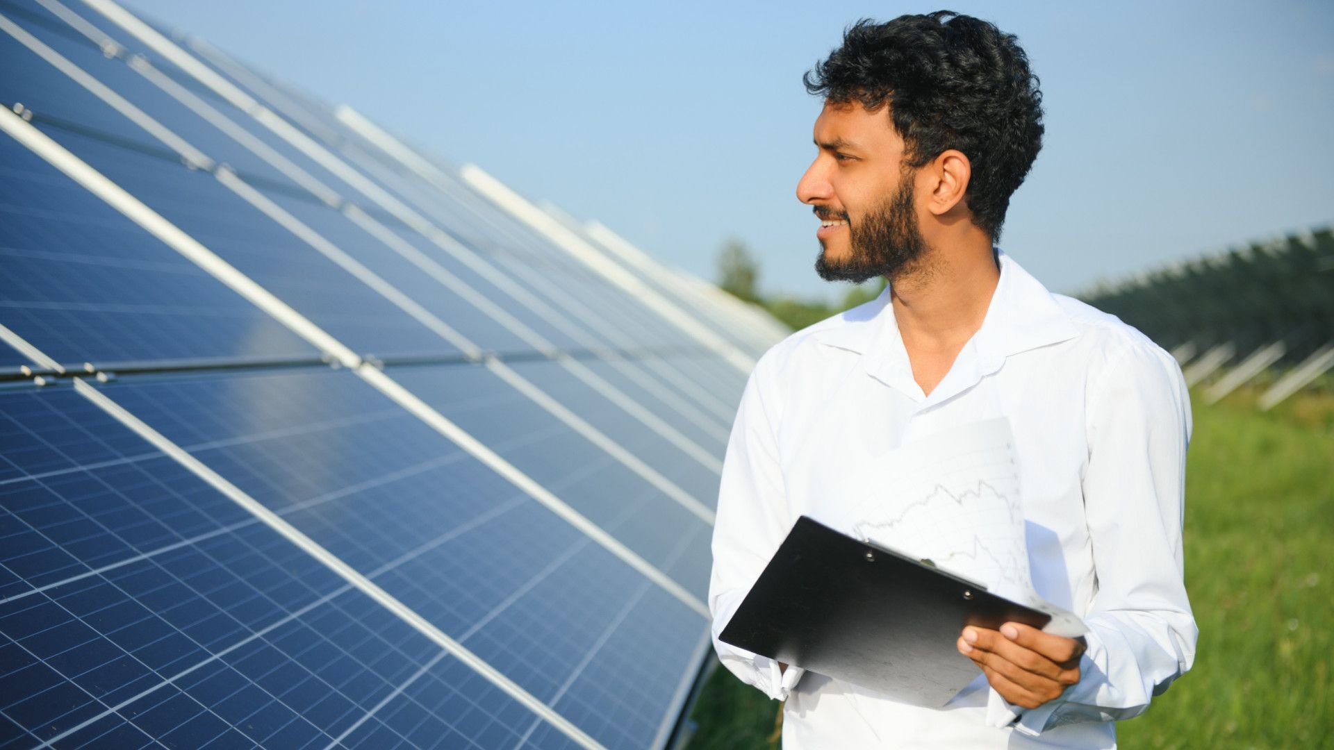a worker checking over solar panels