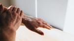 Hand rubbing cream into arm