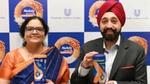 Two people holding Horlicks containers, Hindustan Unilever Limited backdrop.