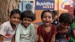 A group of four happy Indian children.