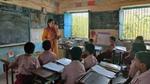 Hul Waste No More school curriculum on waste management being taught by a schoolteacher to students in a classroom.