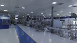 A spacious, modern factory interior with bright lighting