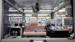 A robot with test tubes in the Materials Innovation Factory.