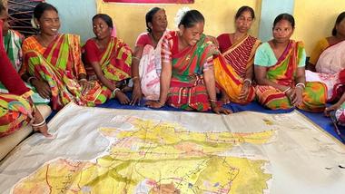Tribal women preparing a watershed map
