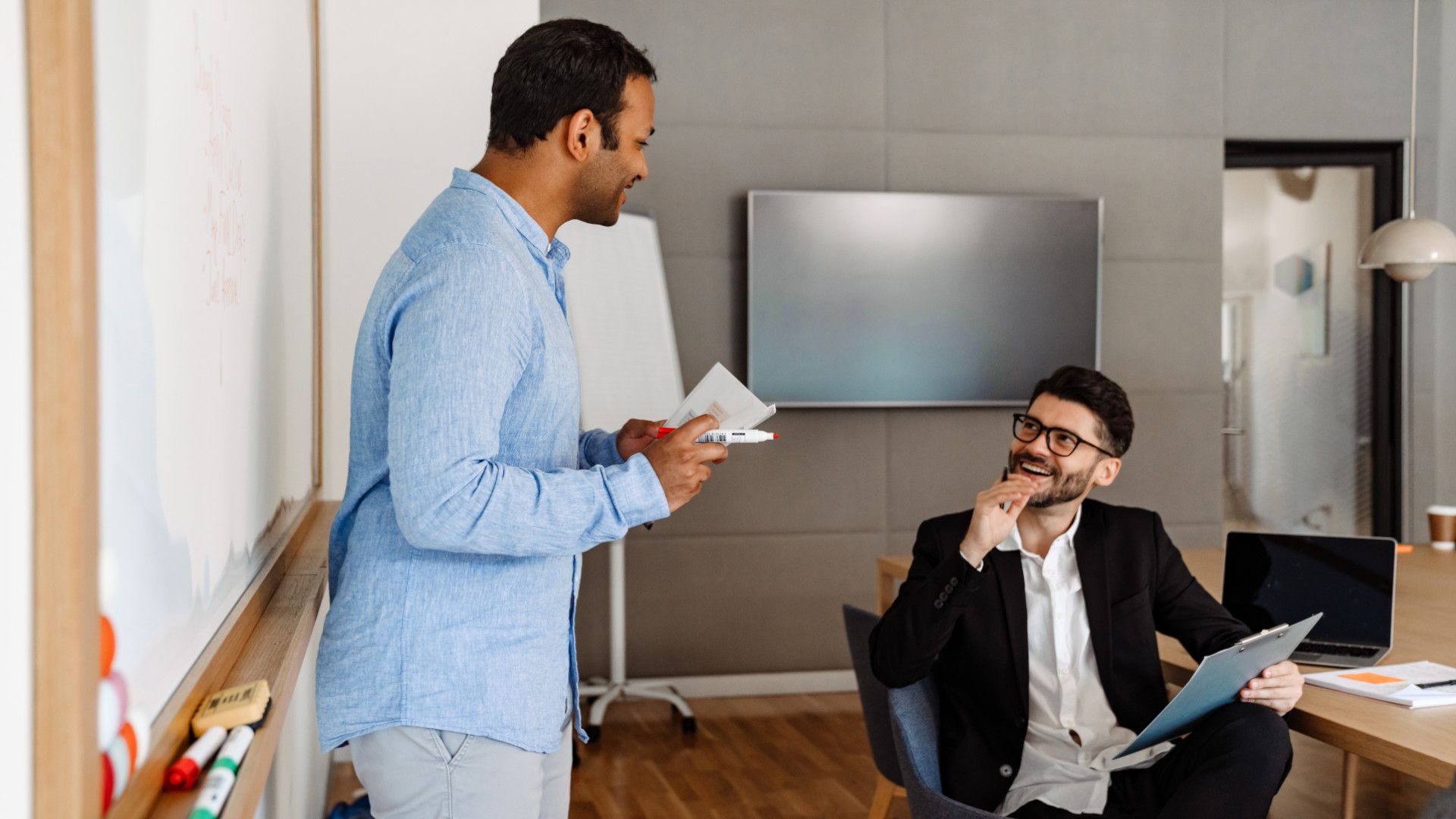 two male colleagues discussing
