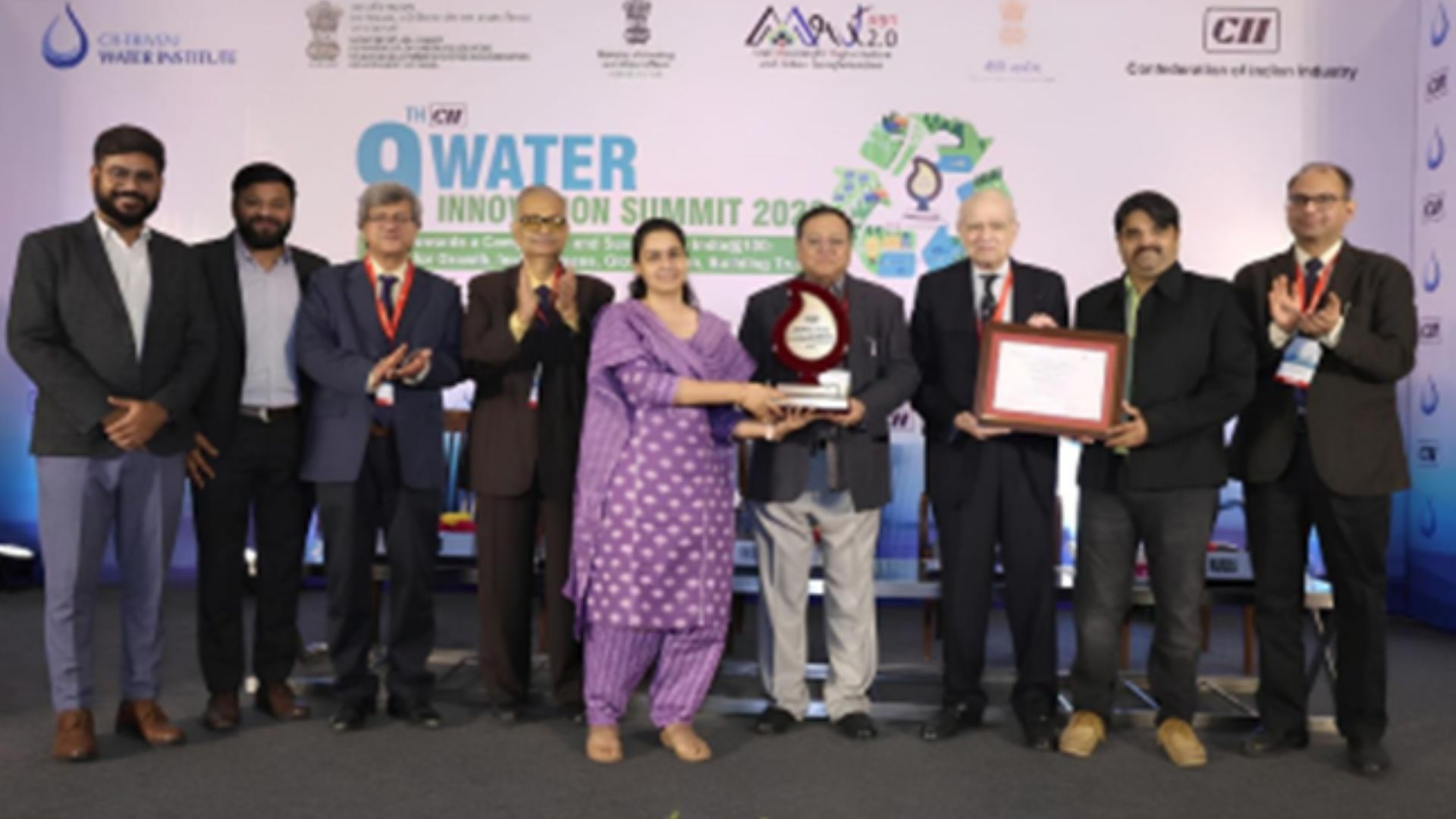 Image of 9 people at an awards ceremony.